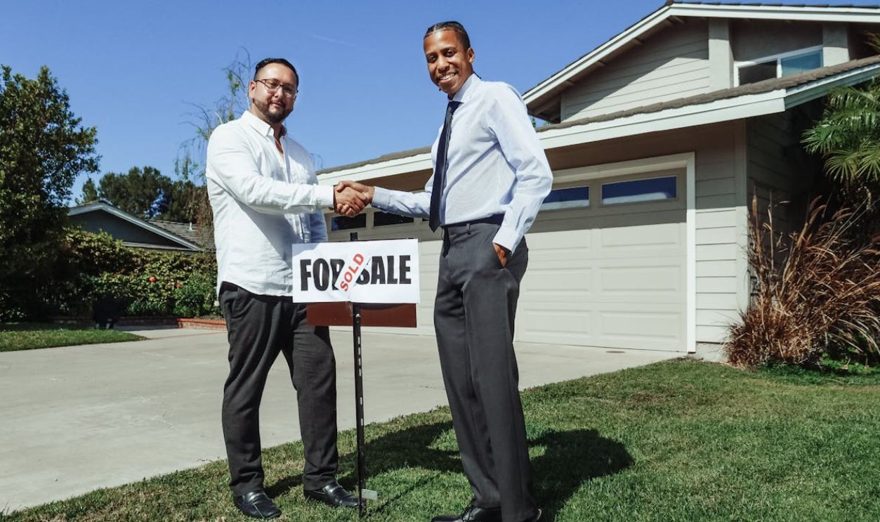 Men in Dress Shirt In Front of a House