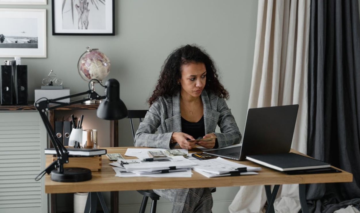 Woman in Gray Suit Working inside the Office