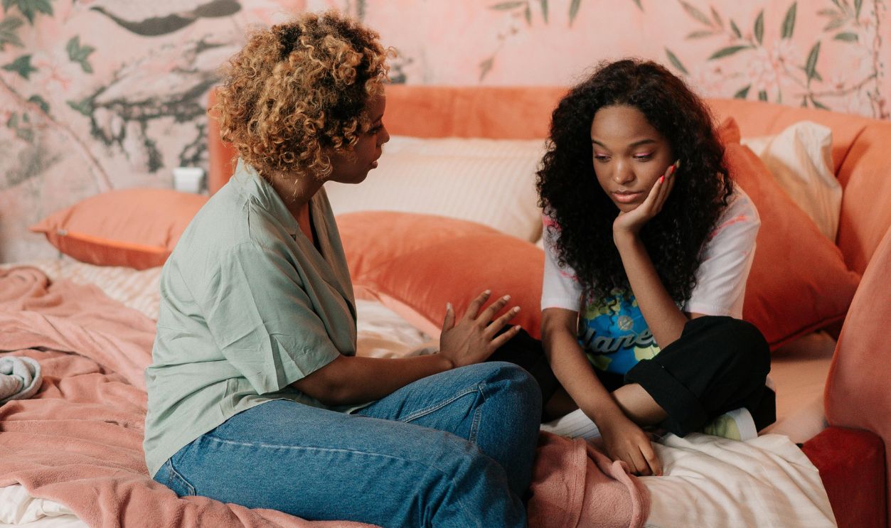 Mother and Daughter Sitting on Bed