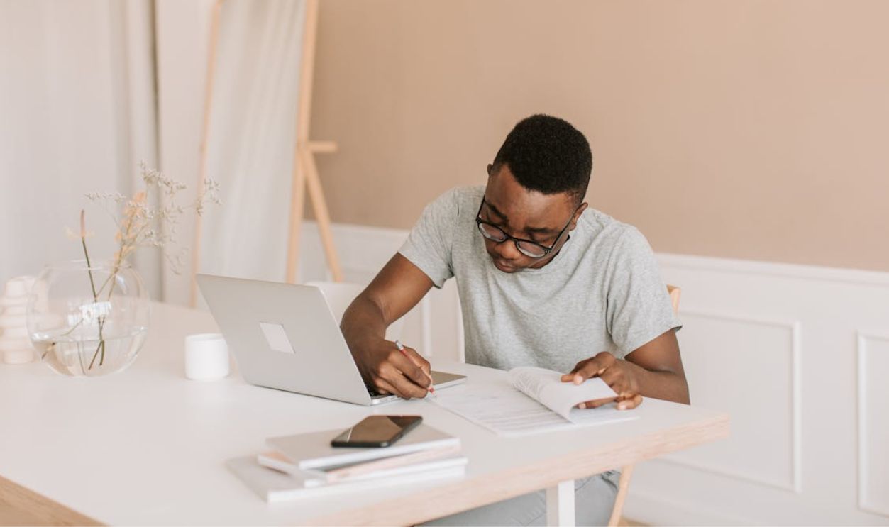 A Man in Gray T shirt Writing