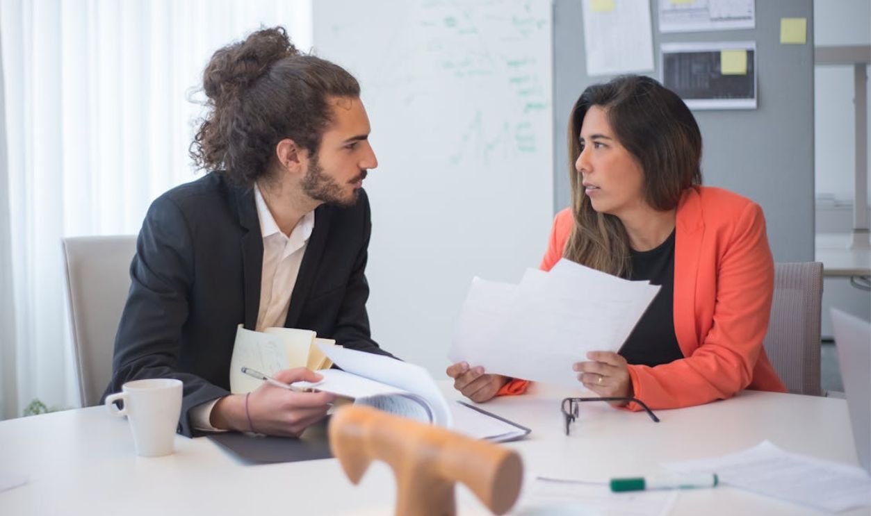 Bearded Man Talking to a Woman at the Office