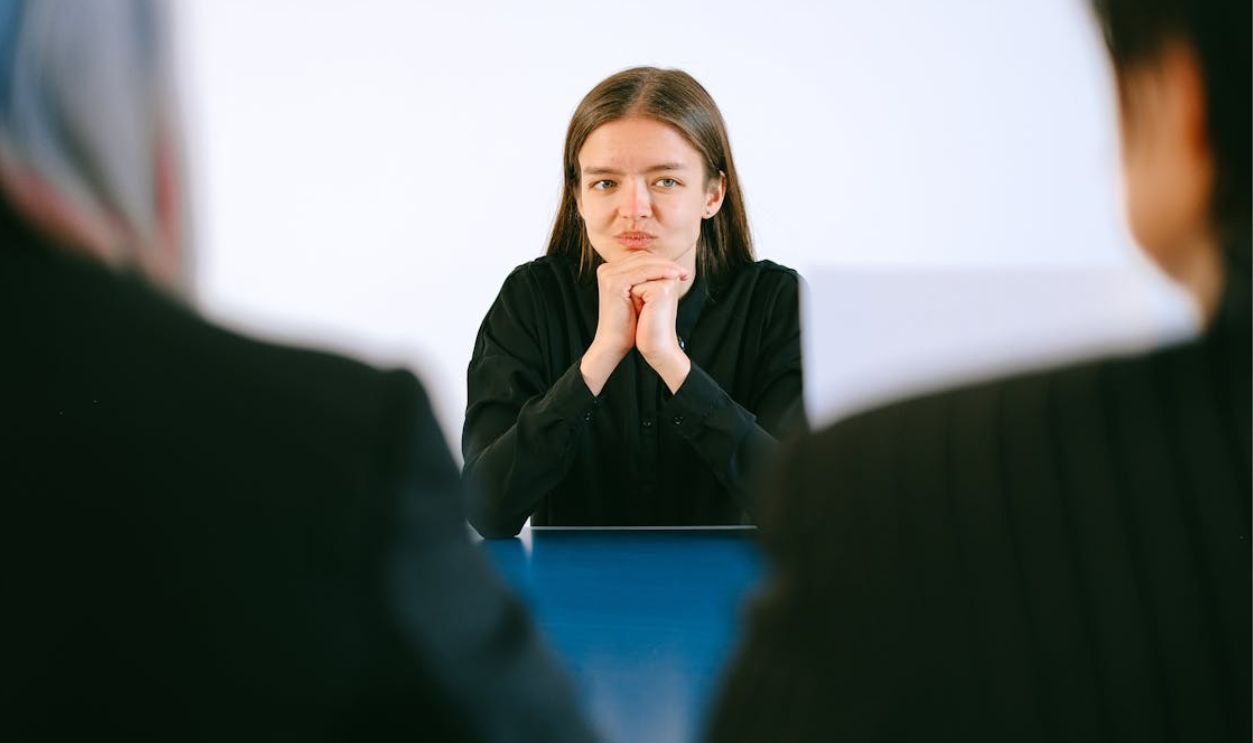 Woman in Black Blazer Sitting Being Interview