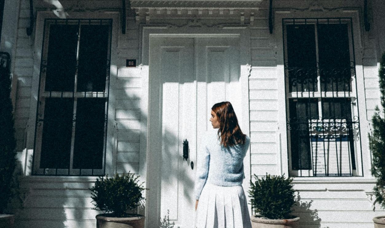 A Woman Standing Outside a House
