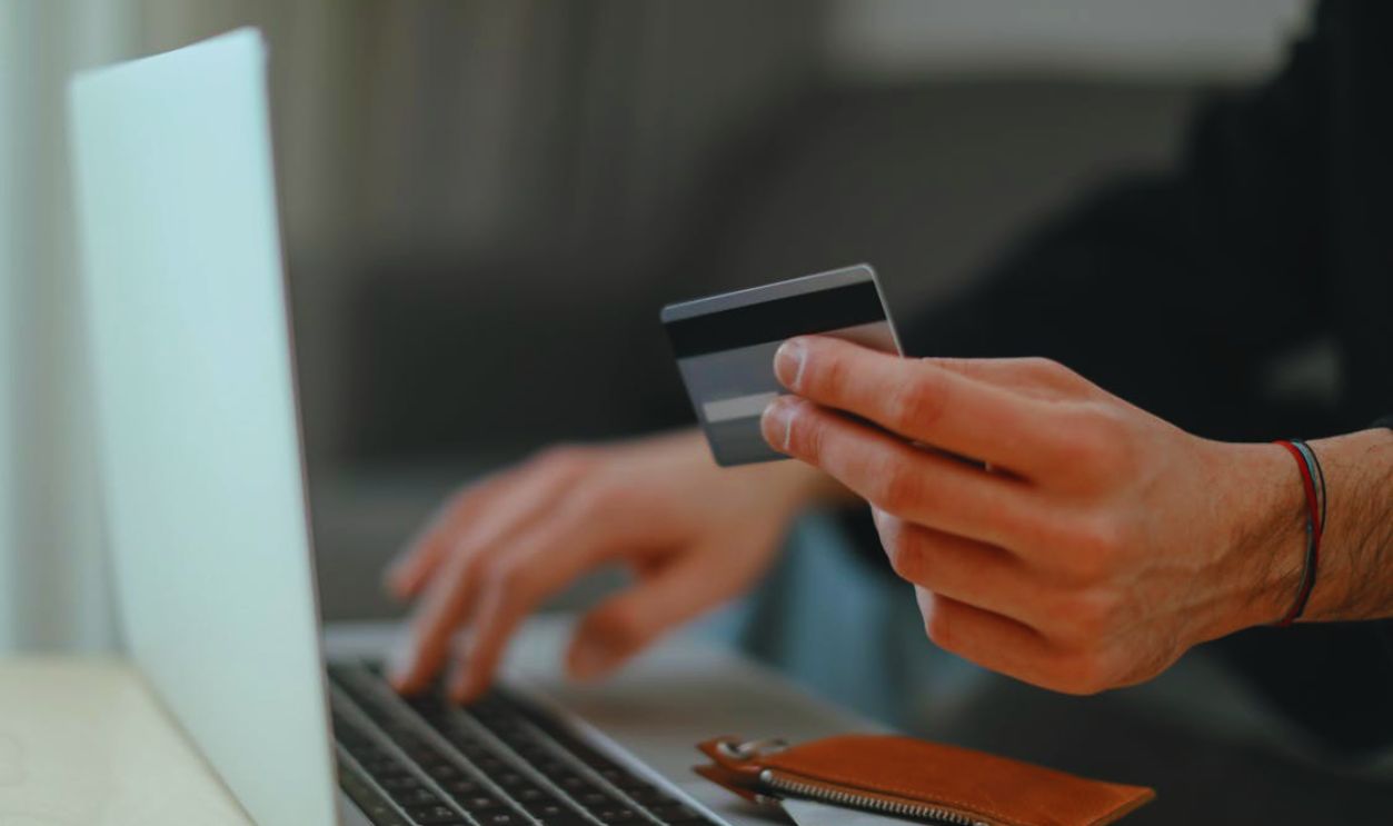 Close Up of Man Hands Using Credit Card Online