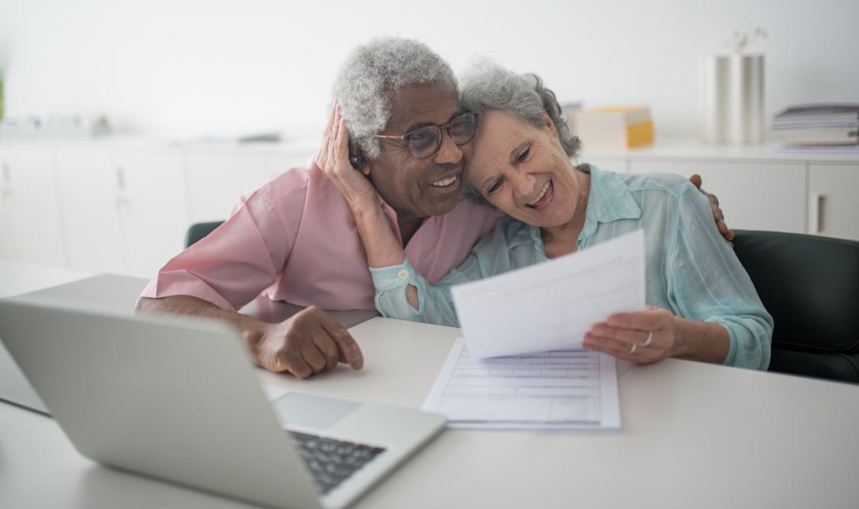 A Happy Elderly Couple Holding a Document