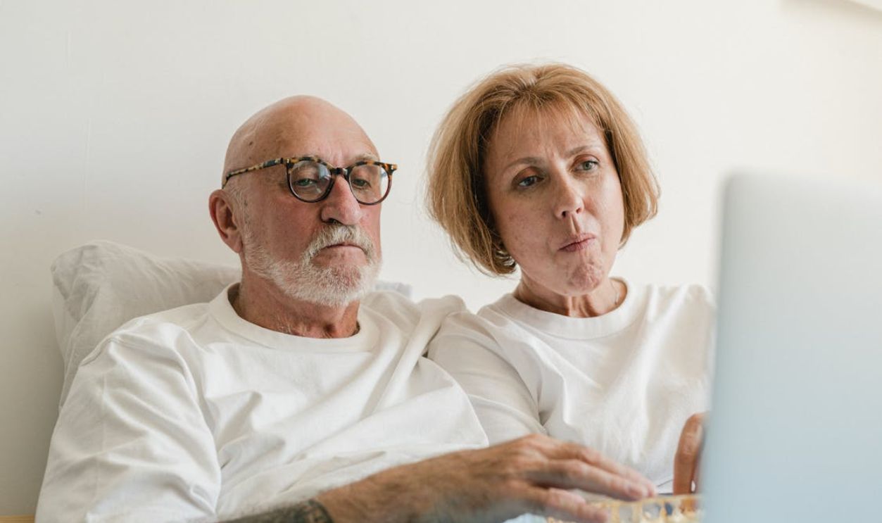 Elderly Couple Looking at the Screen of a Laptop