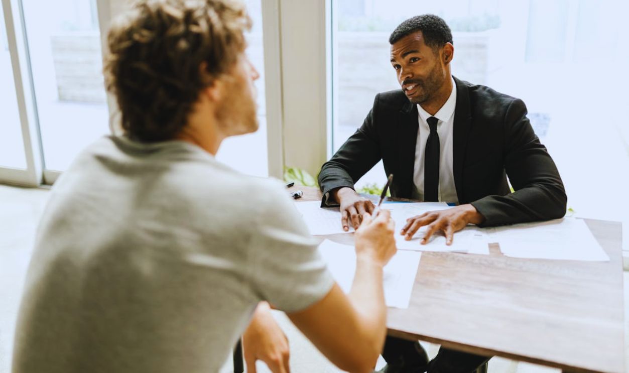 Man in Black Suit Jacket Holding White Paper