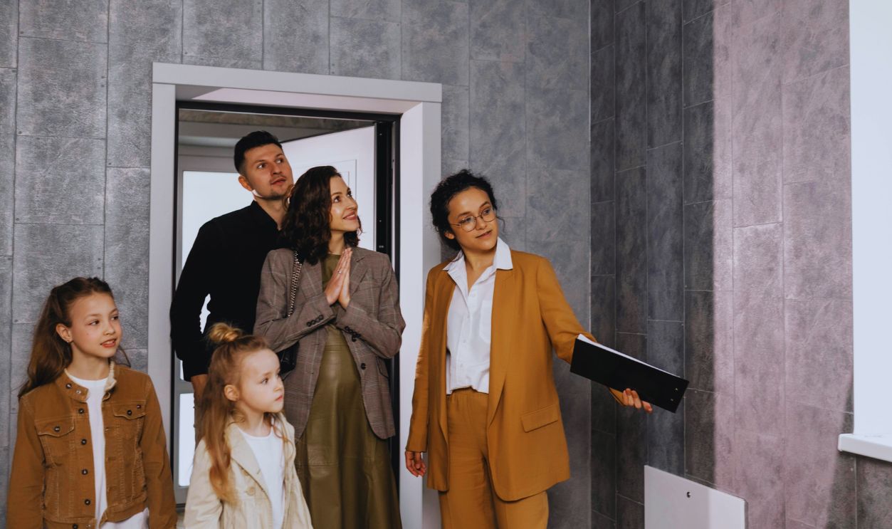 Woman in Brown Suit Standing Beside Woman in Gray Blazer