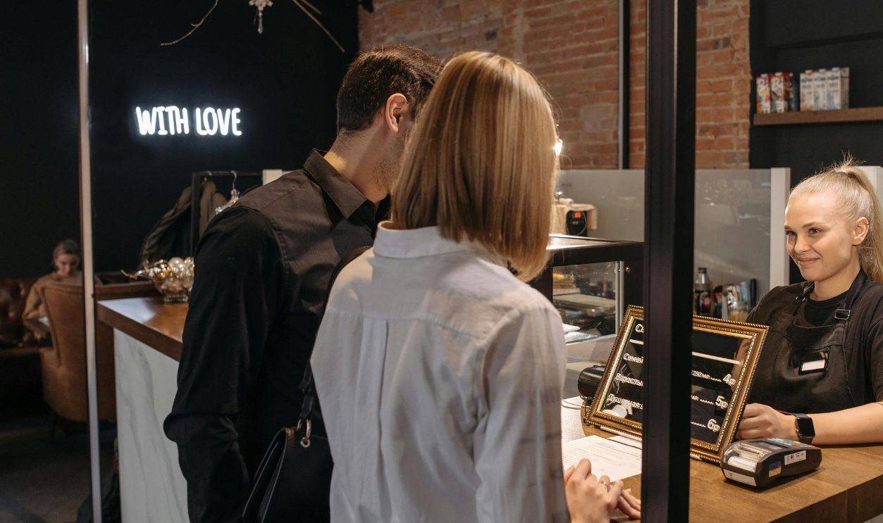 A Woman Standing Behind the Counter of a Coffee Shop