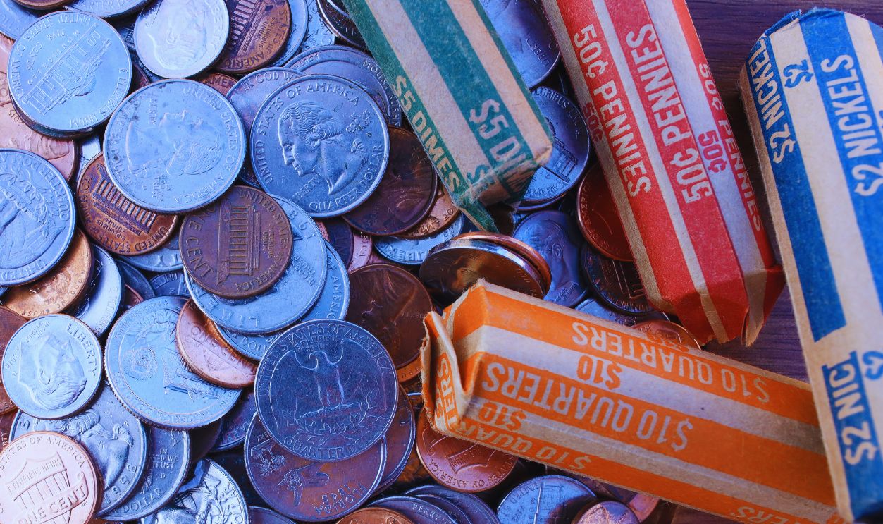 Close up of rolled coins and loose change