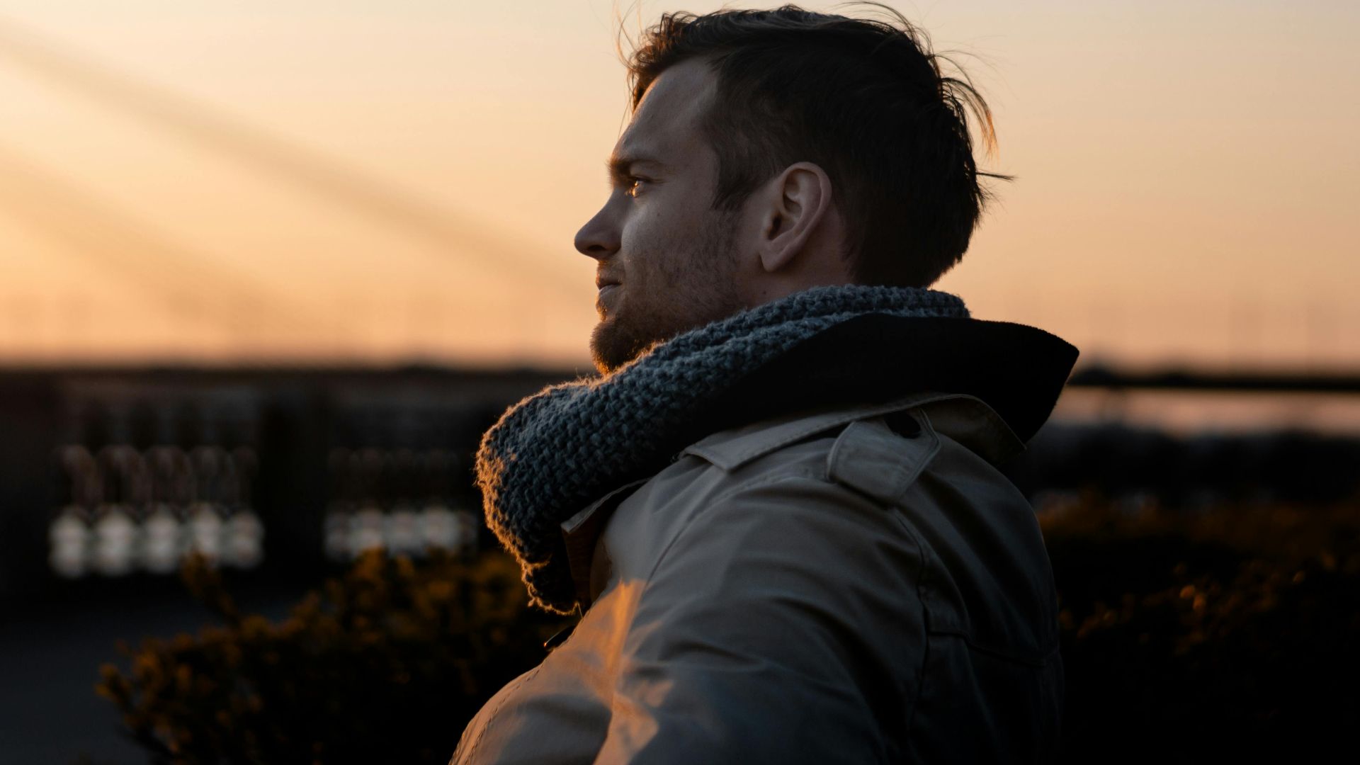 A man enjoys a tranquil moment at sunset outdoors, embodying leisure and tranquility.