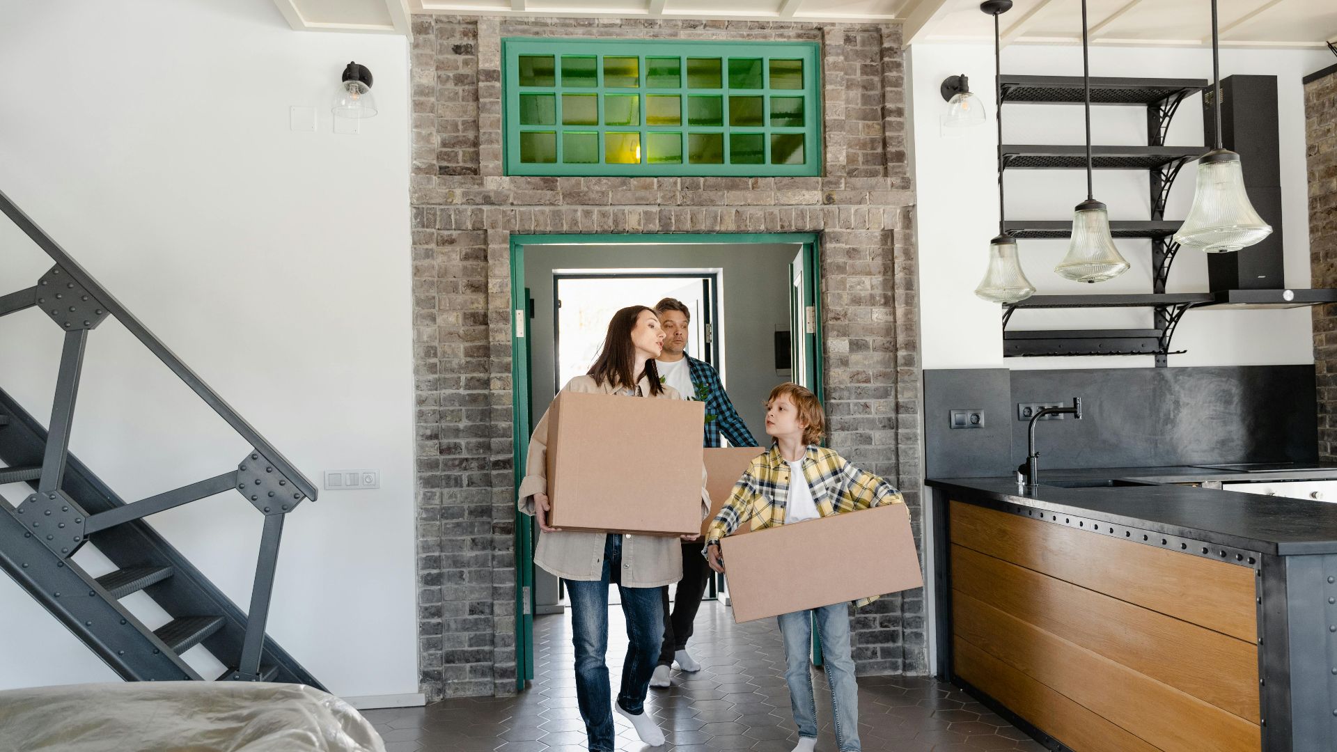 Family carrying boxes into new home, excited for fresh start. Modern interior design.
