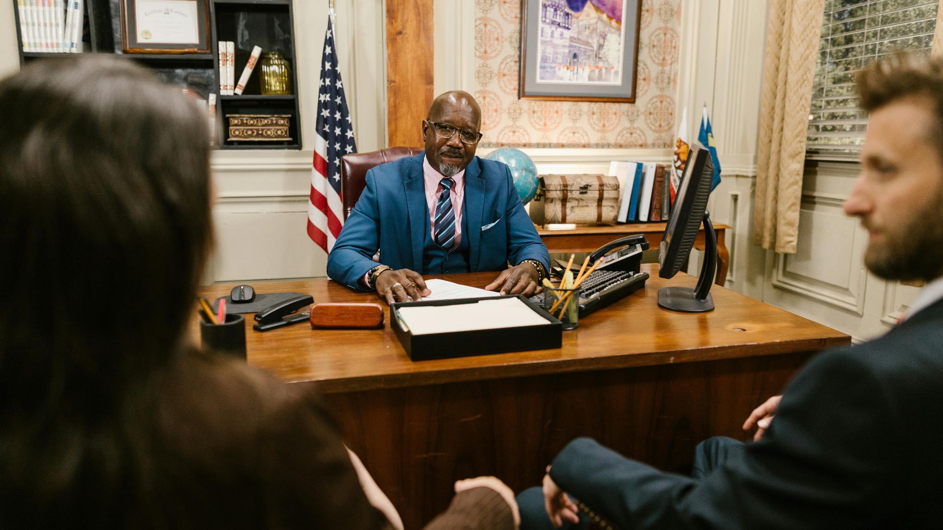 A professional lawyer meeting with clients in his office at a legal consultation.