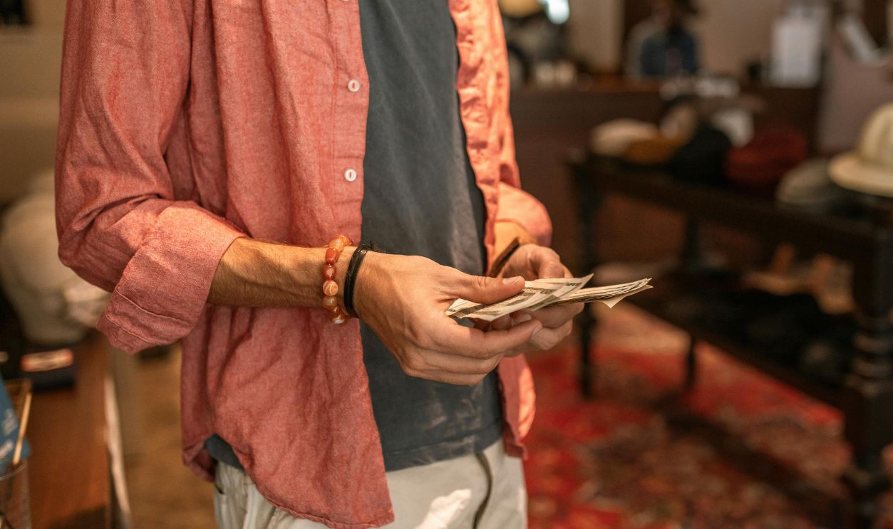 A Person's Hands Holding Money