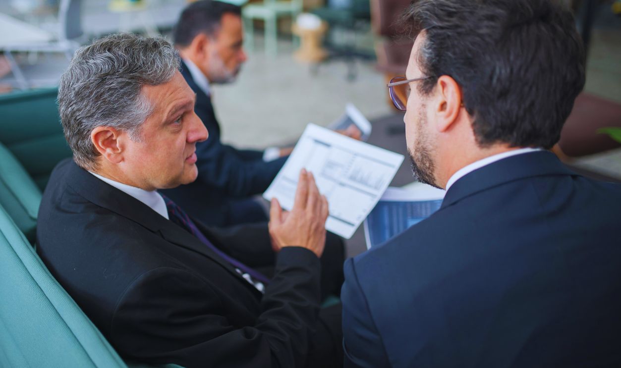 Men Sitting on Sofa Having a Discussion