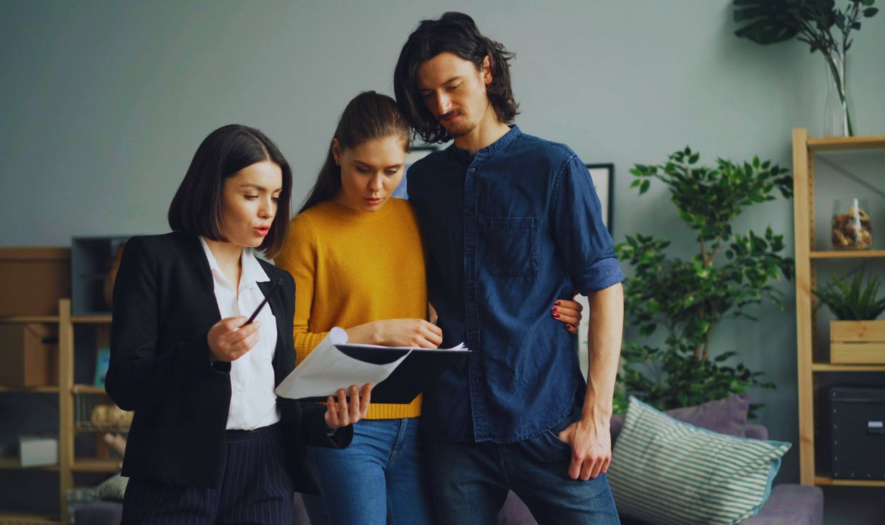 Couple Standing with Real Estate Agent