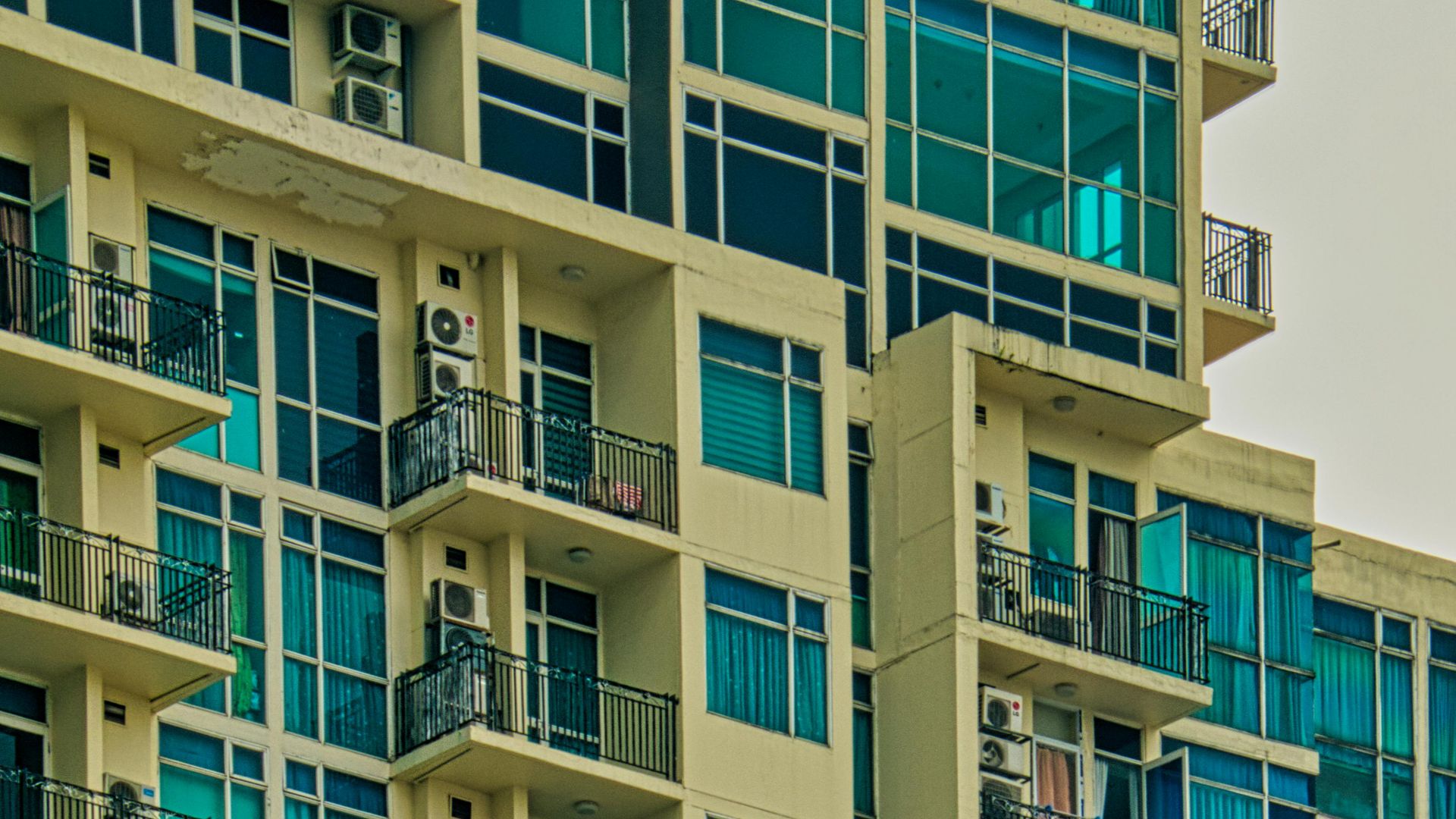 Contemporary multi-storey building in Jakarta featuring geometric patterns and balconies.