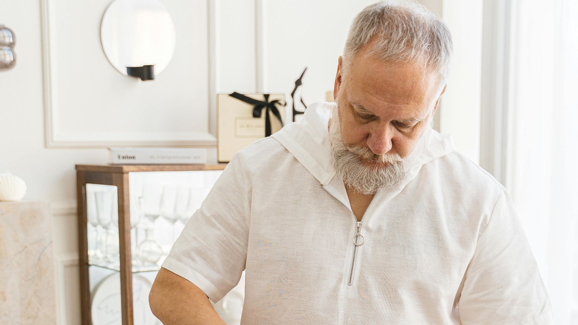 Senior man arranging groceries indoors, symbolizing self-care and independence