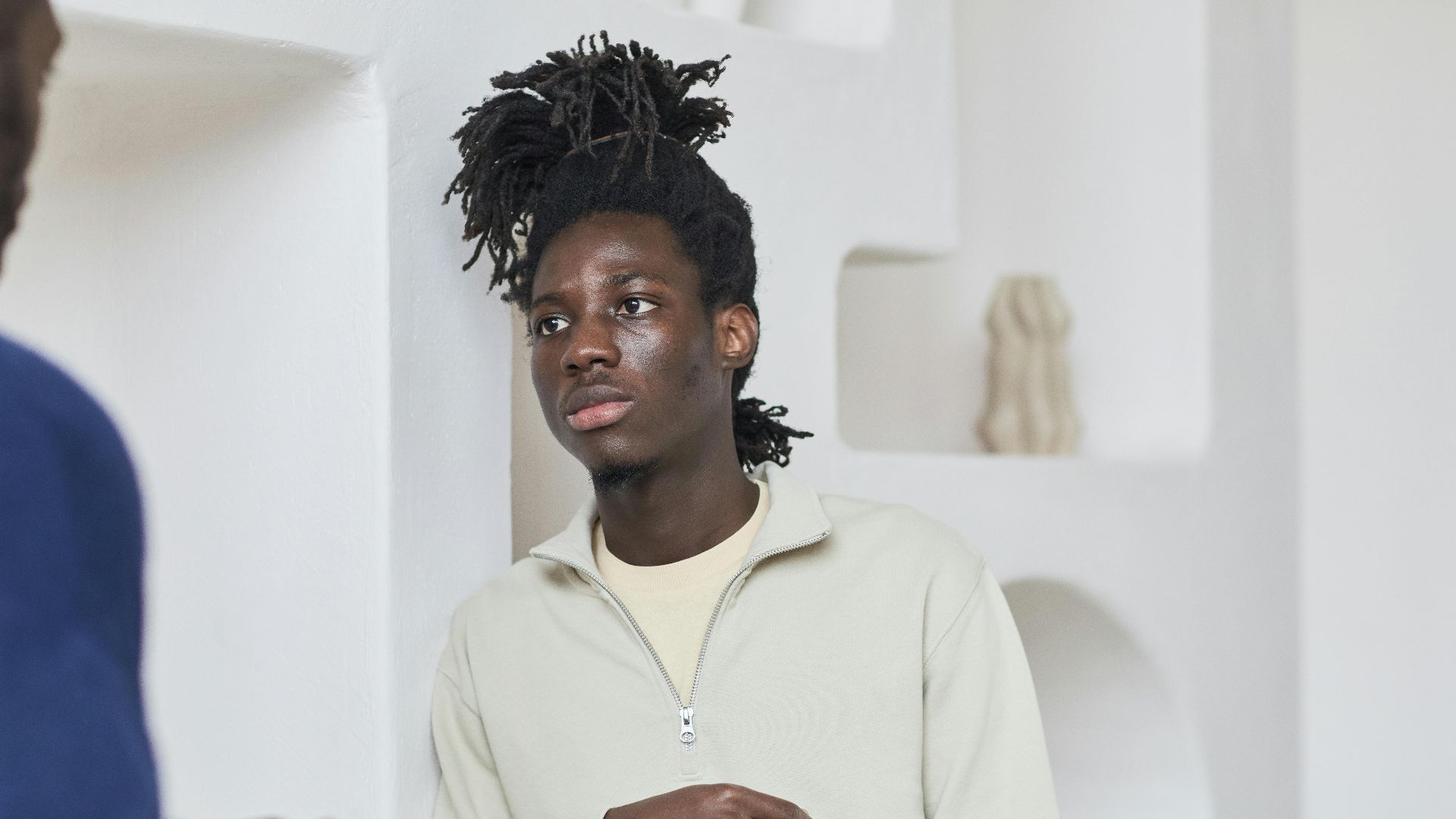 Two men talking and listening in an indoor setting, capturing a moment of engagement and communication.