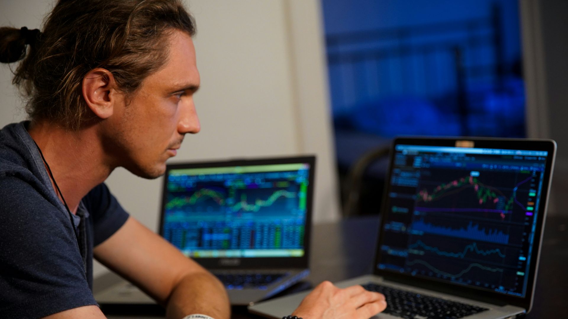 man sitting in front of the MacBook Pro