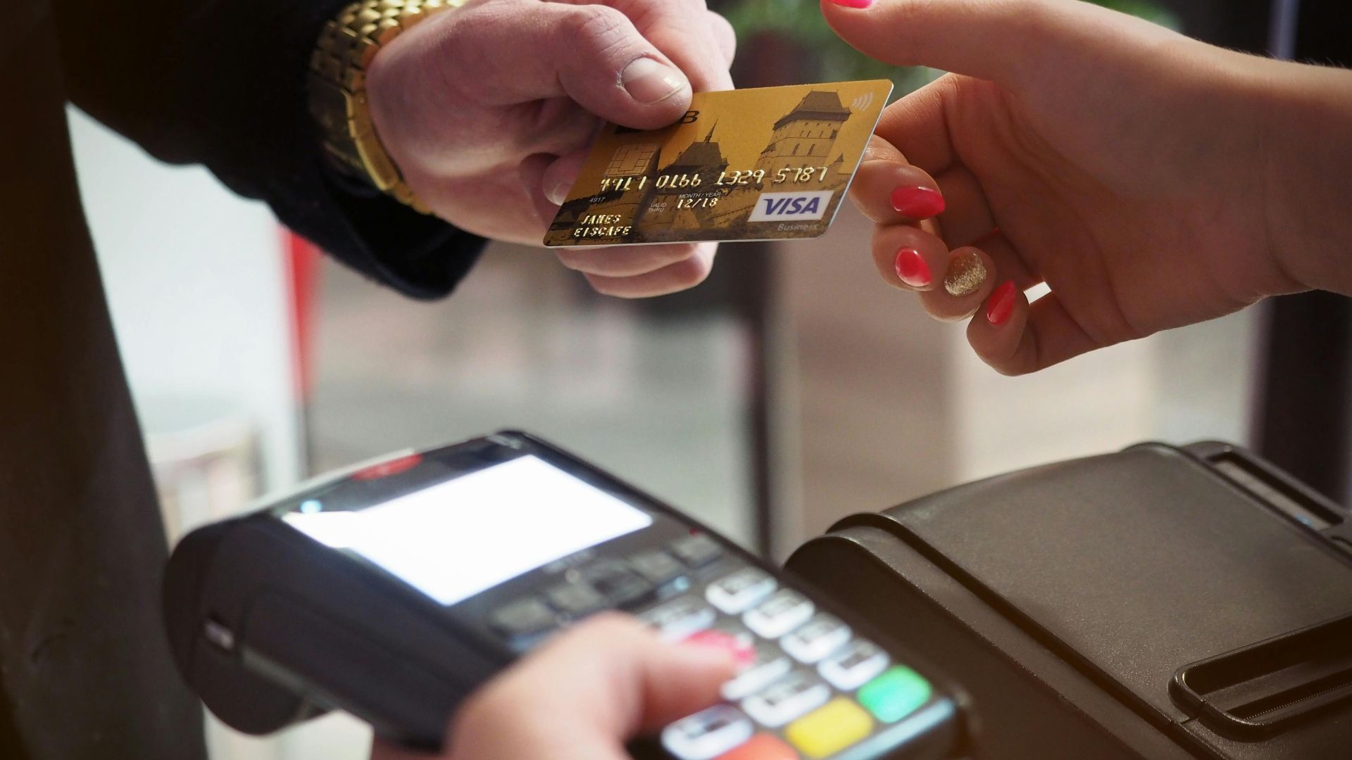 Close-up of a credit card payment being processed at a POS terminal.