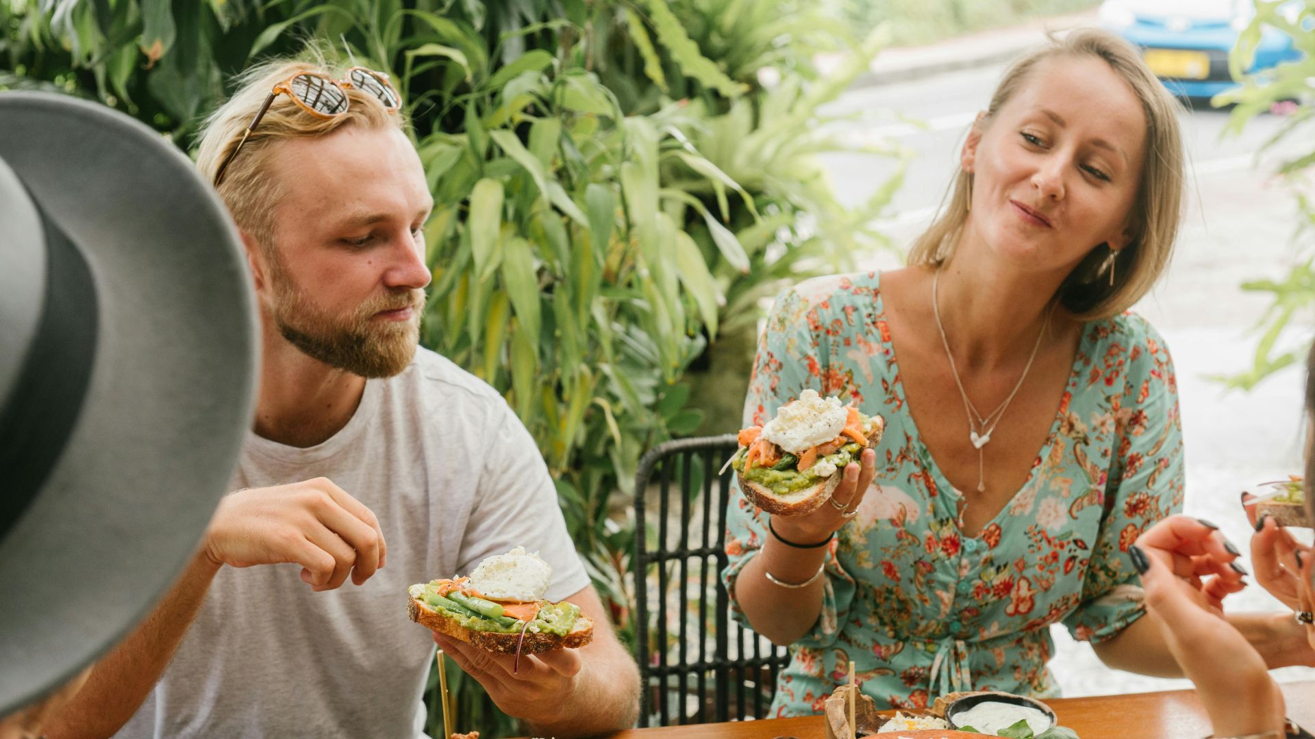 Group of friends enjoying a fresh, healthy meal outdoors during the summer.