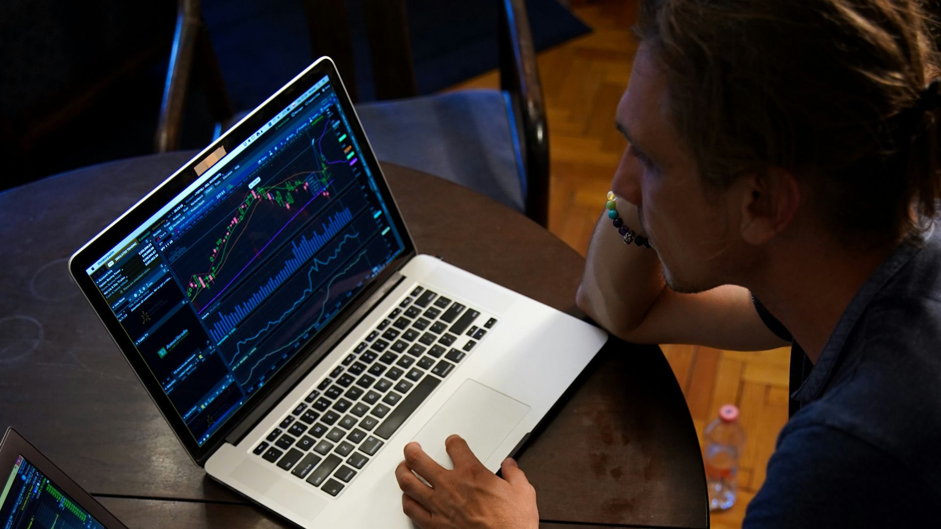 man sitting in front of the MacBook Pro