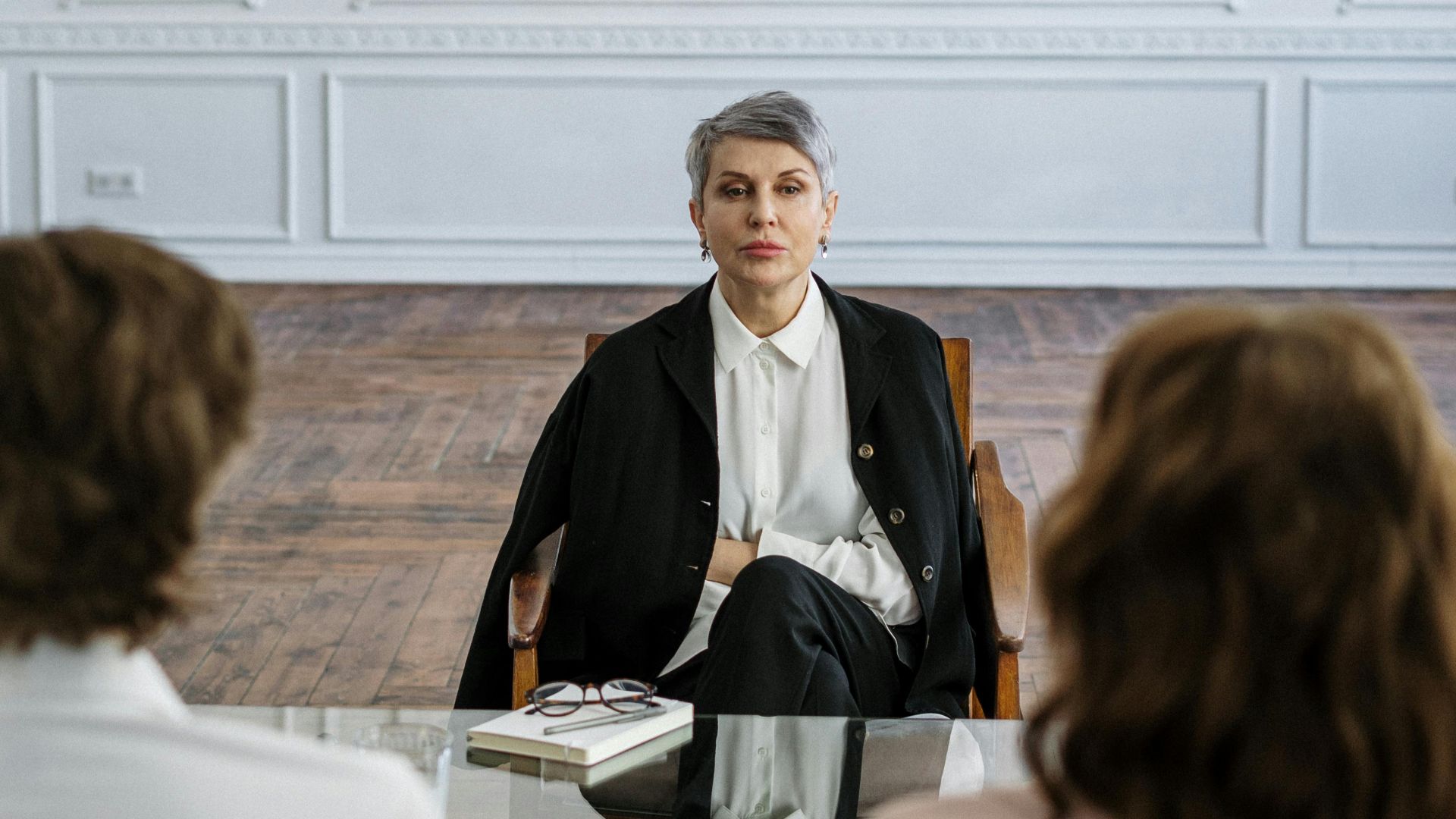 Couple receiving guidance from therapist in a stylish and serene office setting.