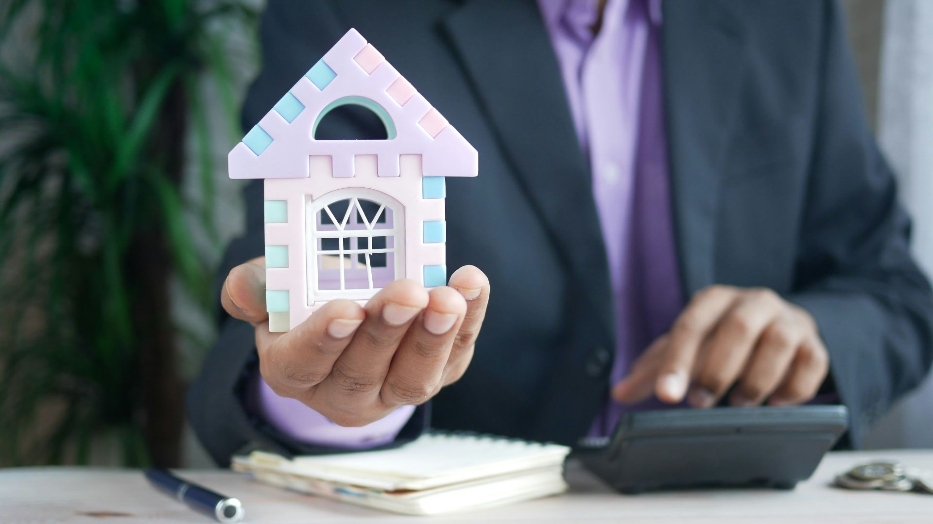 man in purple suit jacket using laptop computer
