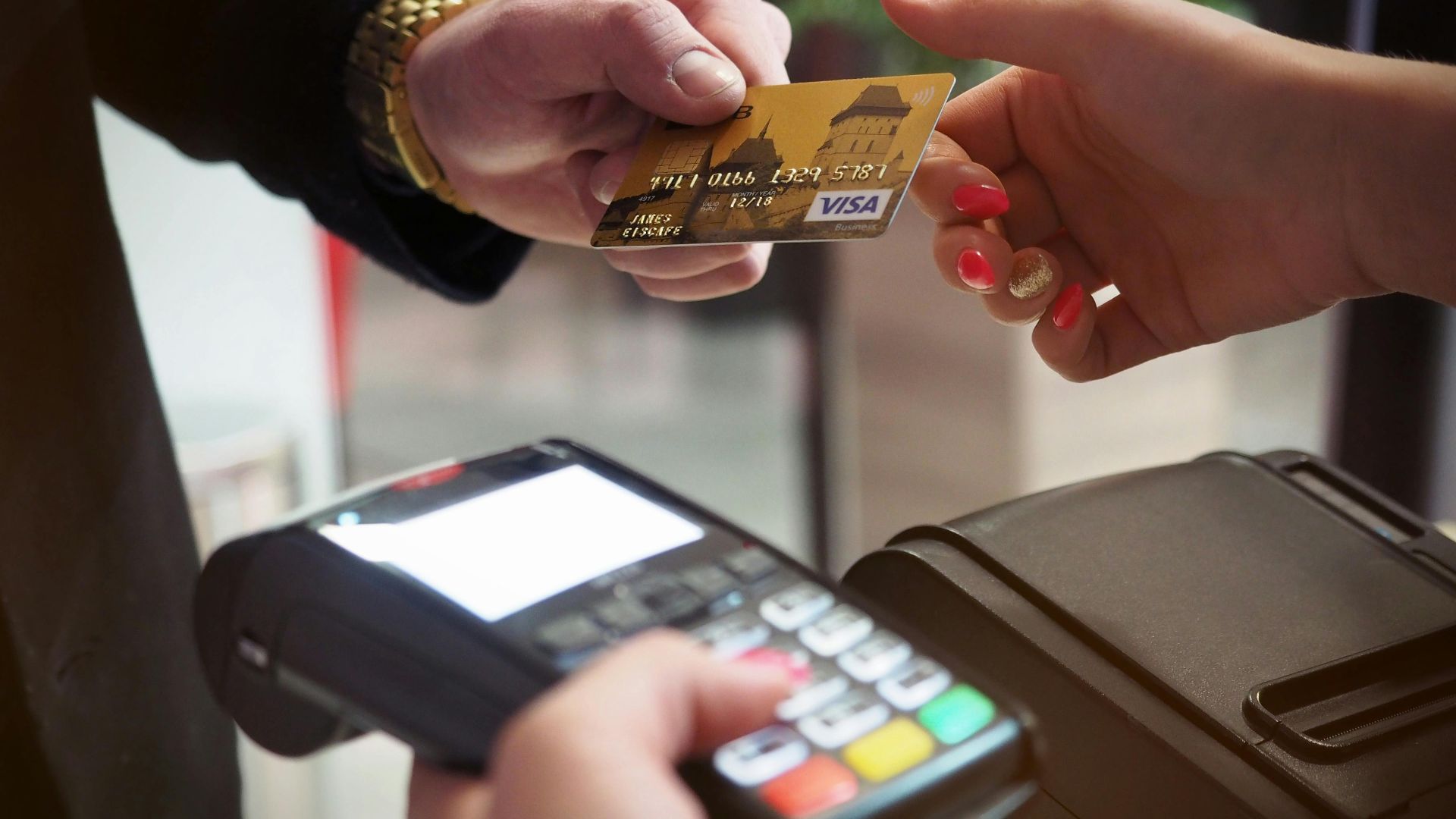 Close-up of a credit card payment being processed at a POS terminal.