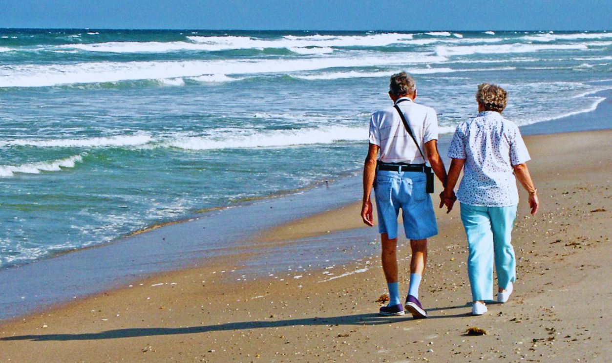 Senior Couple Walking Hand in Hand on Florida Beach