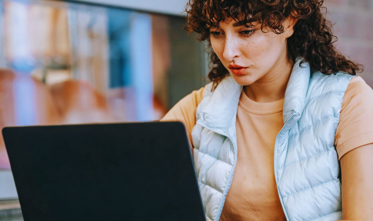 Freelancer working on laptop in street cafeteria