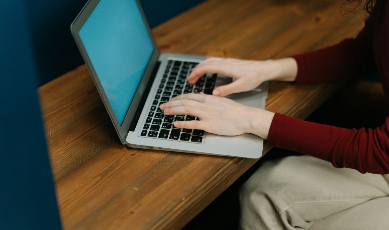 Photo Of Hands Typing On A Laptop