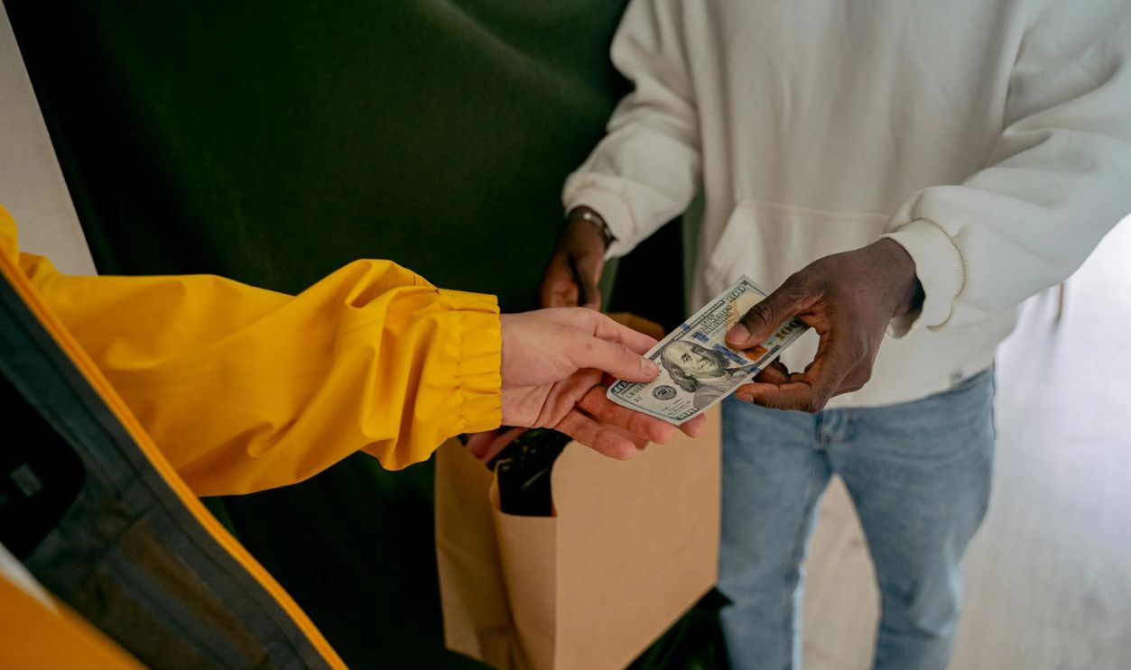 Close up of a Person Paying in Cash