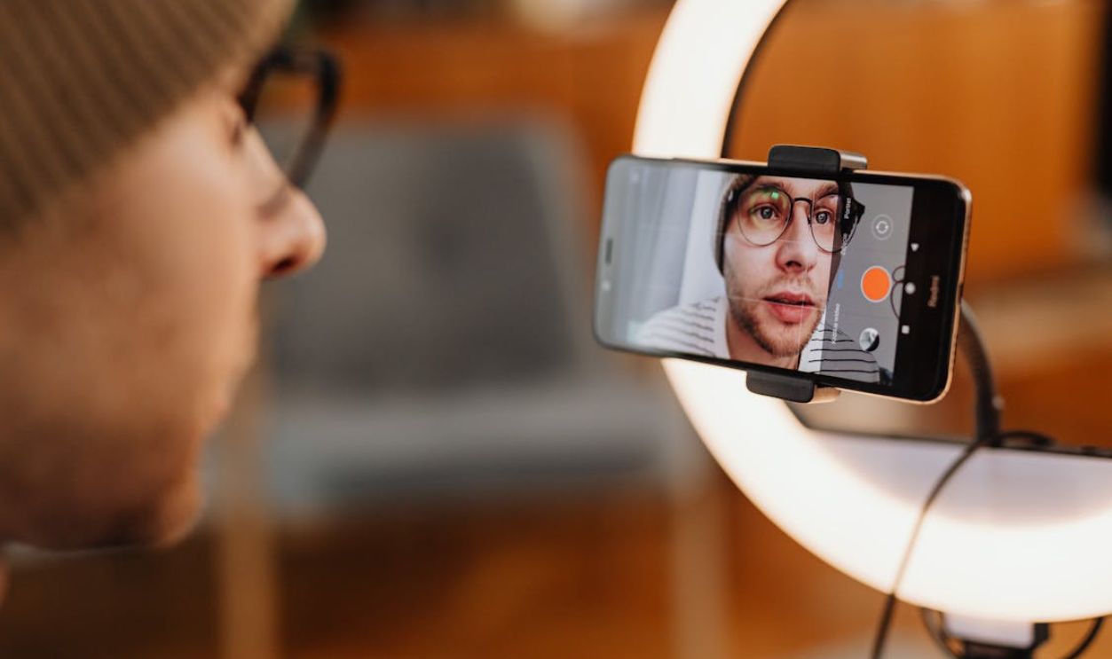 Man Filming Video on Smartphone