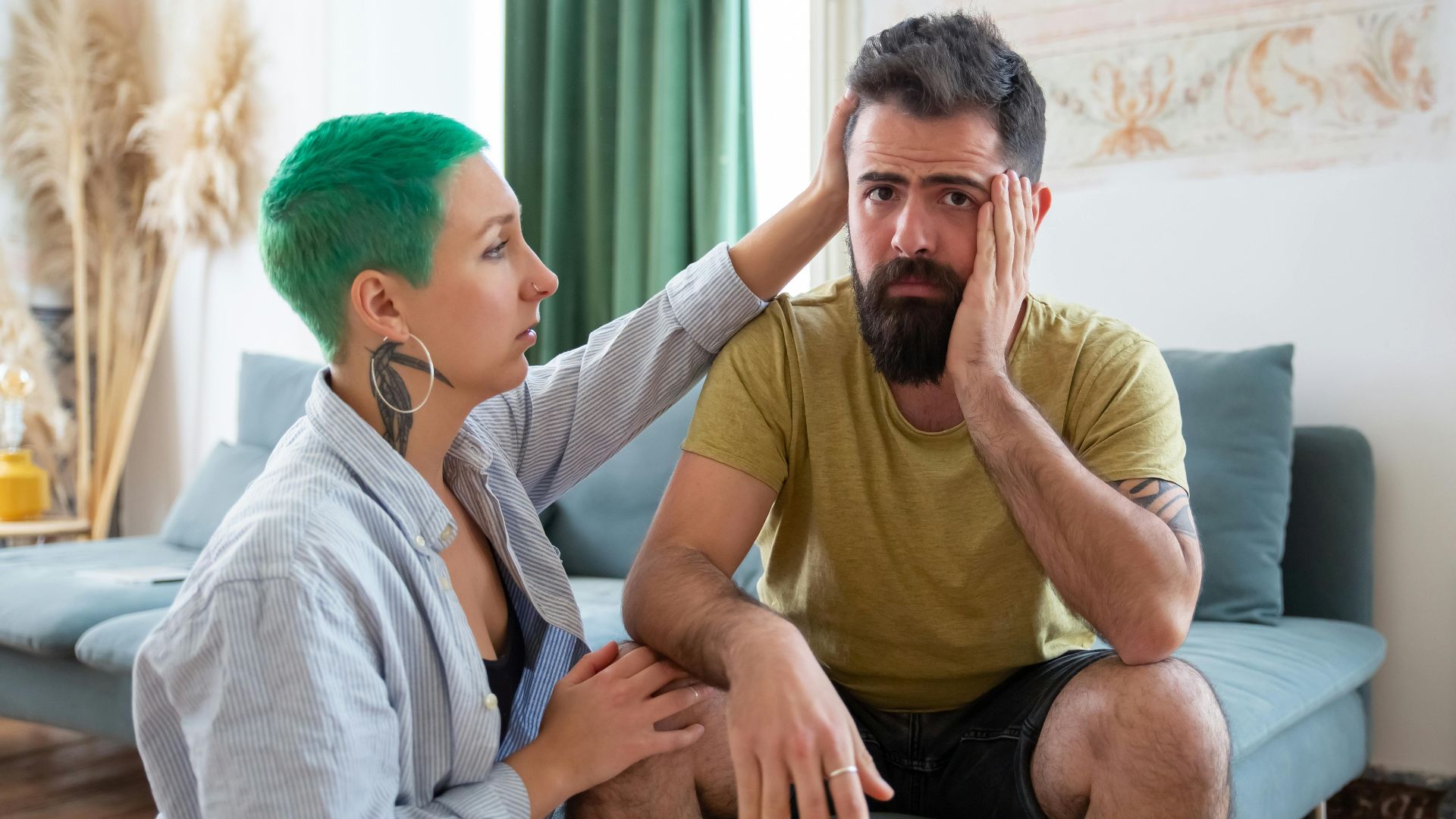 A couple shares an emotional exchange at home, offering comfort and support.
