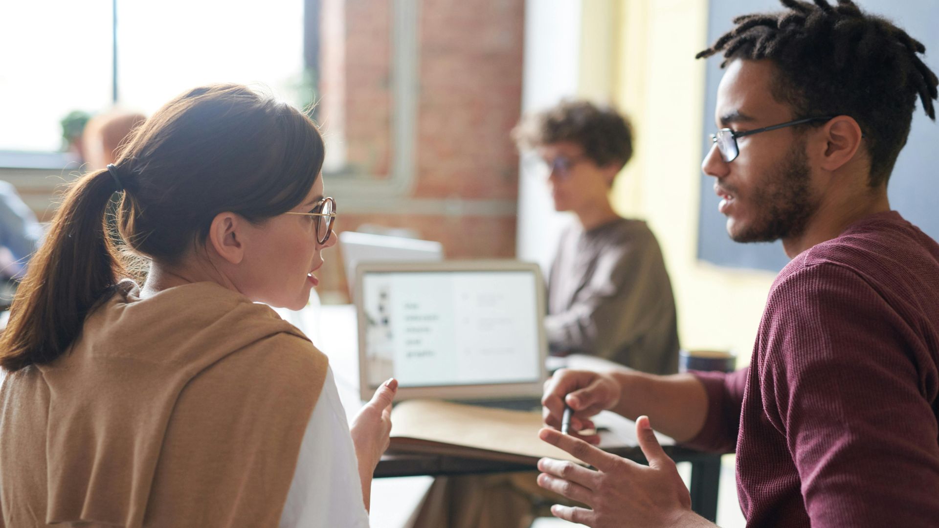 A diverse group of professionals engaged in a collaborative meeting in a modern office setting.