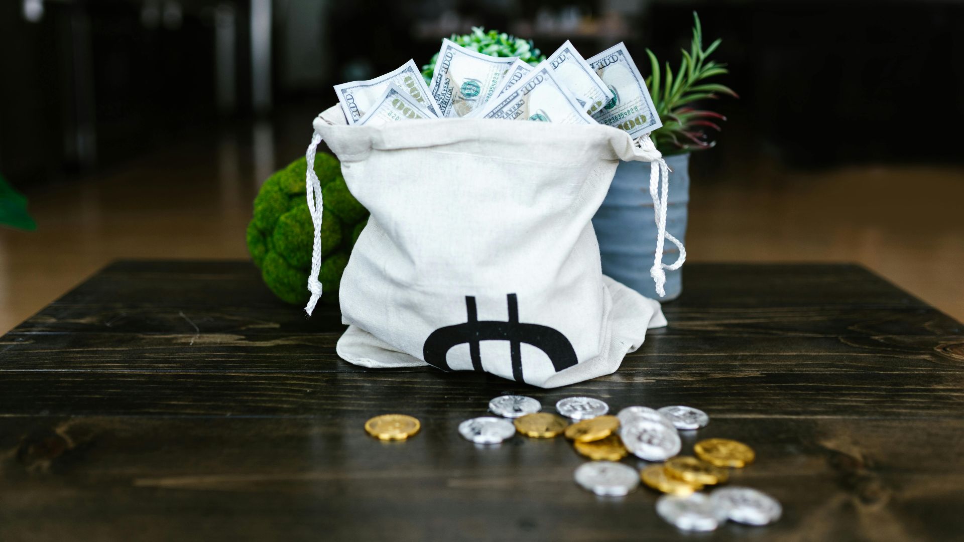A tote bag filled with cash and coins symbolizing cryptocurrency wealth on a wooden table.