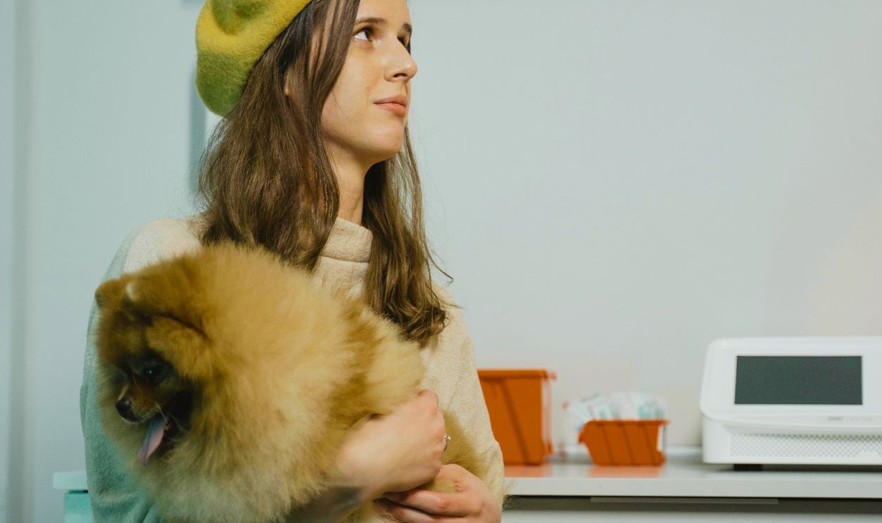 A Woman with Her Dog in the Clinic