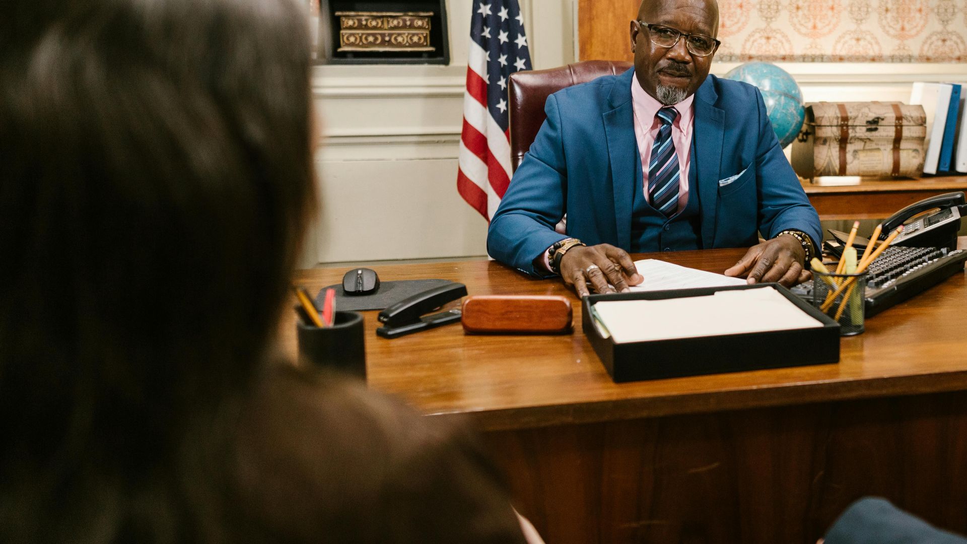 A professional lawyer meeting with clients in his office at a legal consultation.