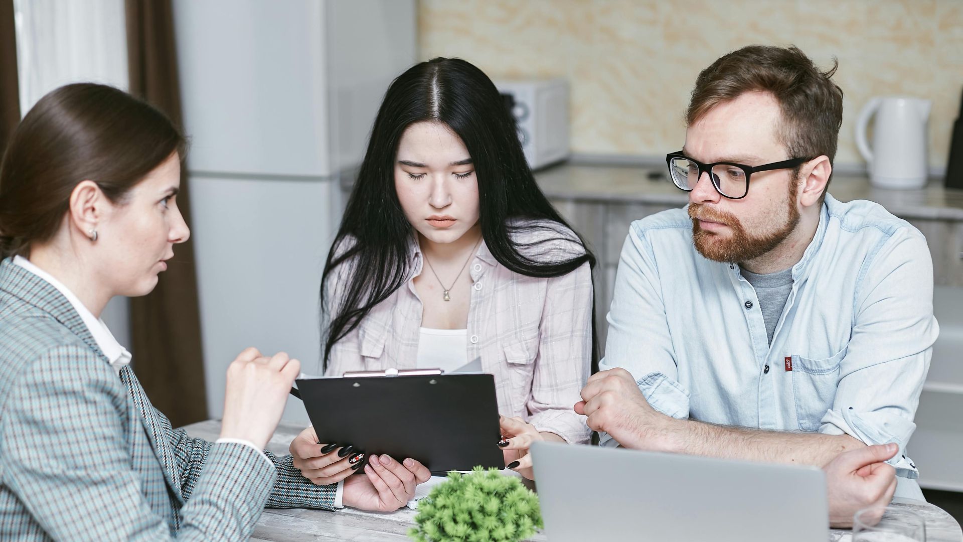 A group of professionals discussing business strategies at a table indoors.