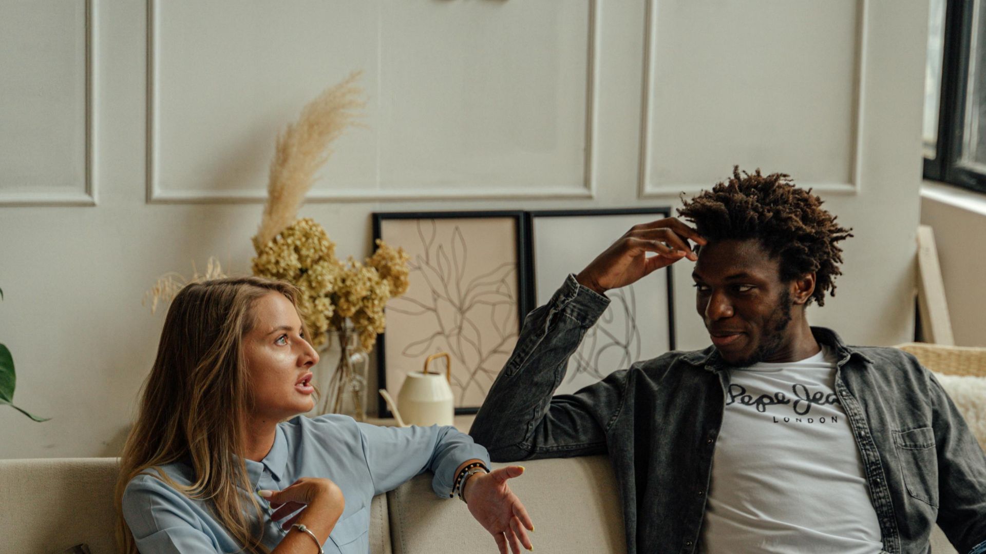 A couple is engaged in a lively conversation during a therapy session with a counselor.