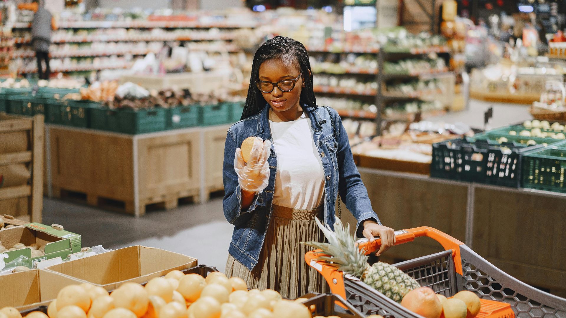 A woman shopping for fresh produce in a vibrant supermarket setting.
