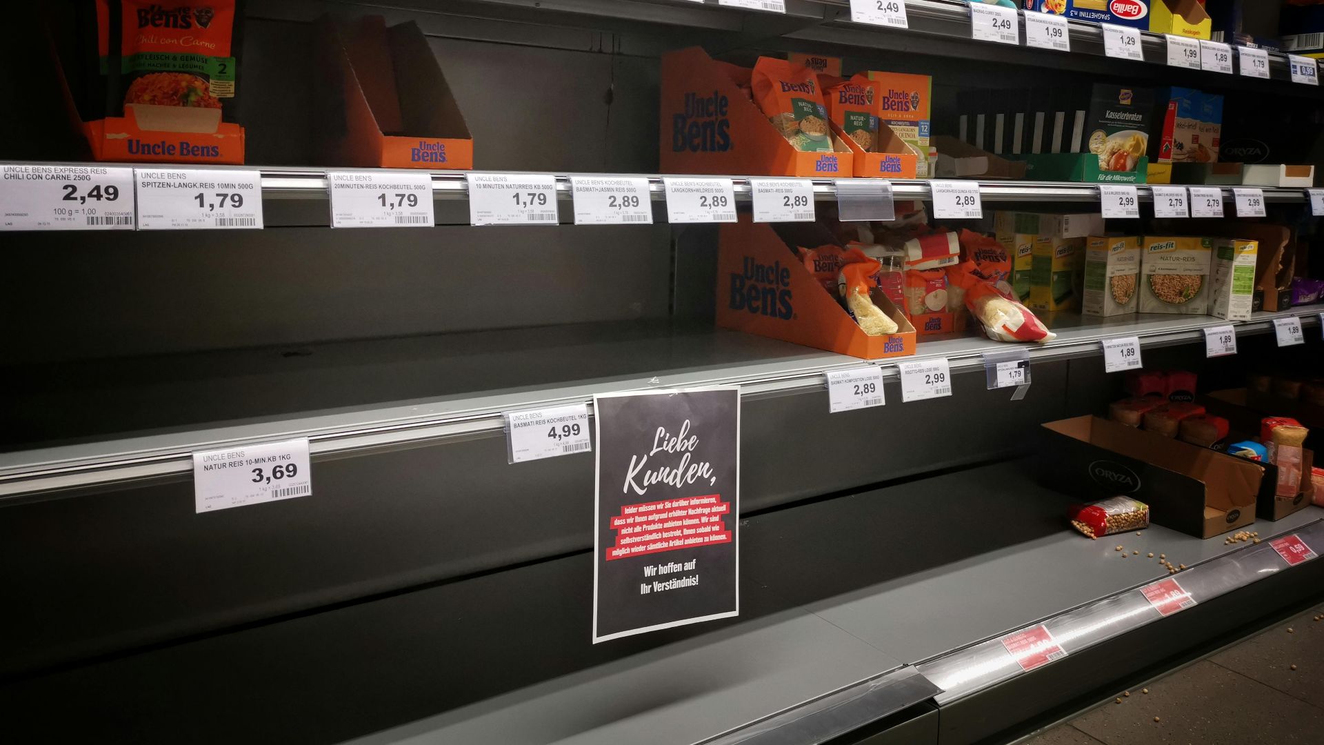 Half empty shelves with assorted products in jars and containers in supermarket during quarantine