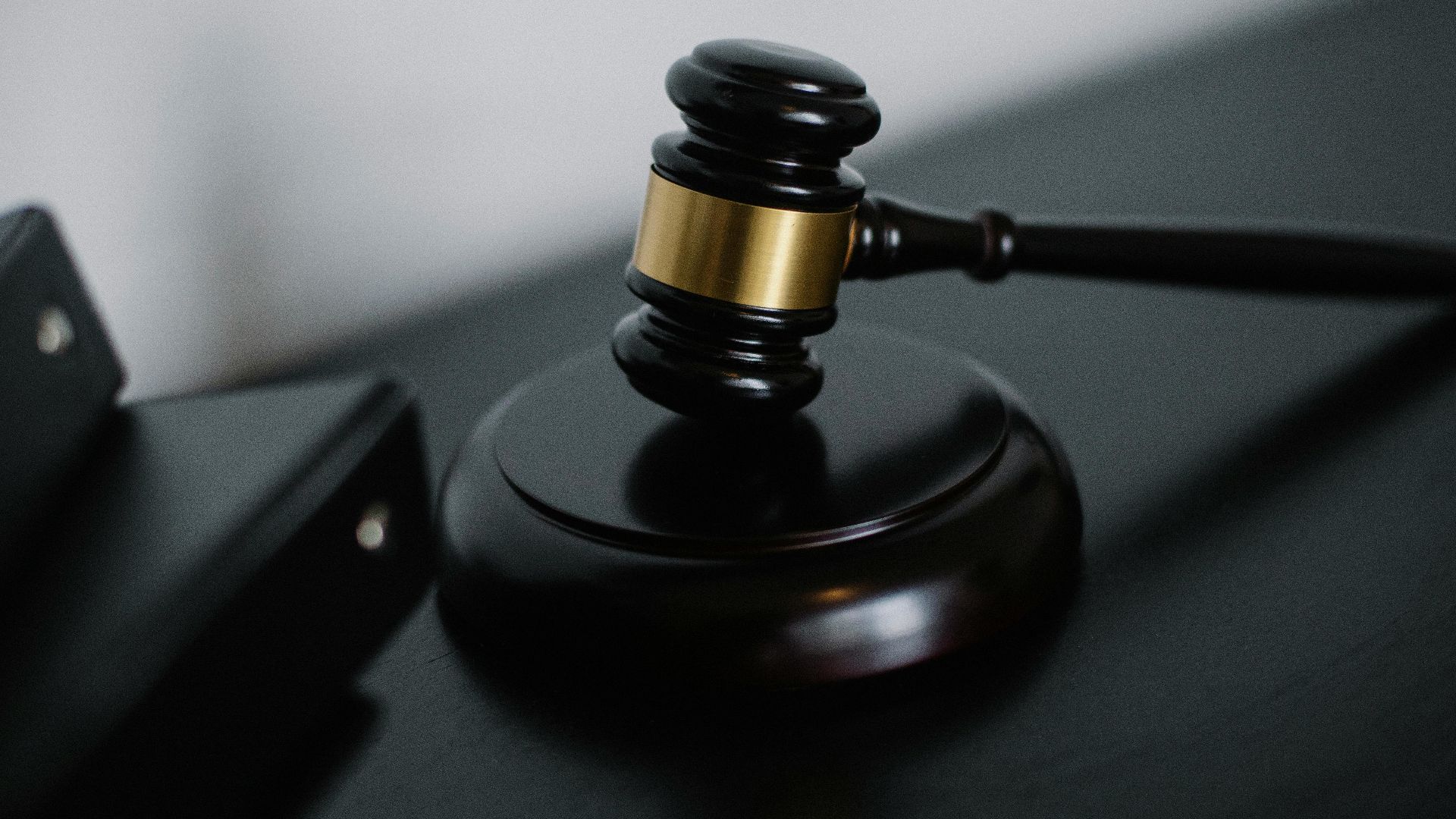 Close-up of a wooden gavel on a desk, symbolizing justice and legal authority.