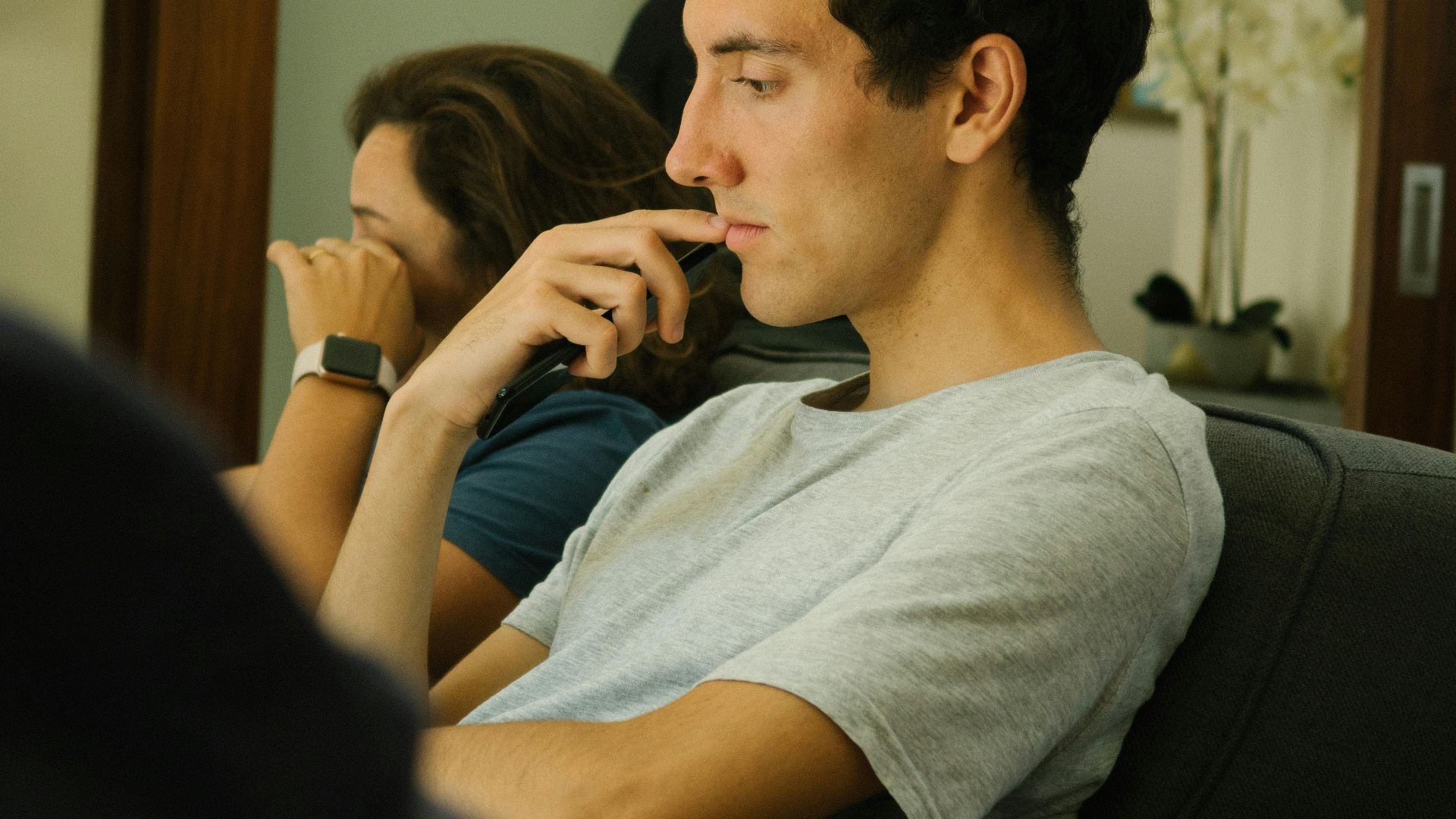 Two people sitting indoors, deep in thought and contemplation.