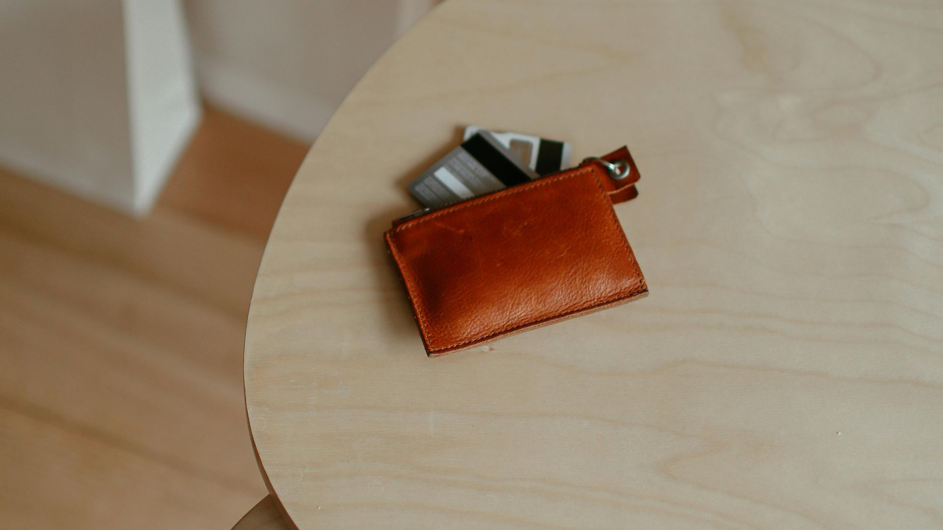 Stylish scene with shopping bags and wallet on a wooden table indoors, ideal for retail themes.