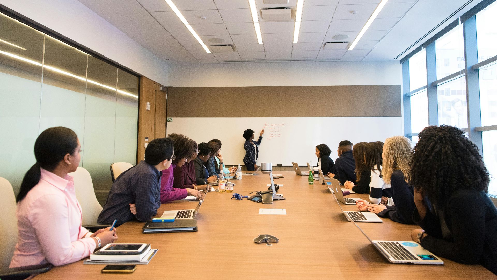 Business meeting with diverse team discussing projects in a modern conference room.
