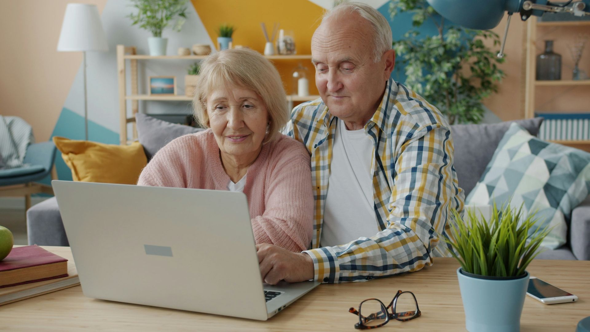 Elderly couple looking at a laptop together