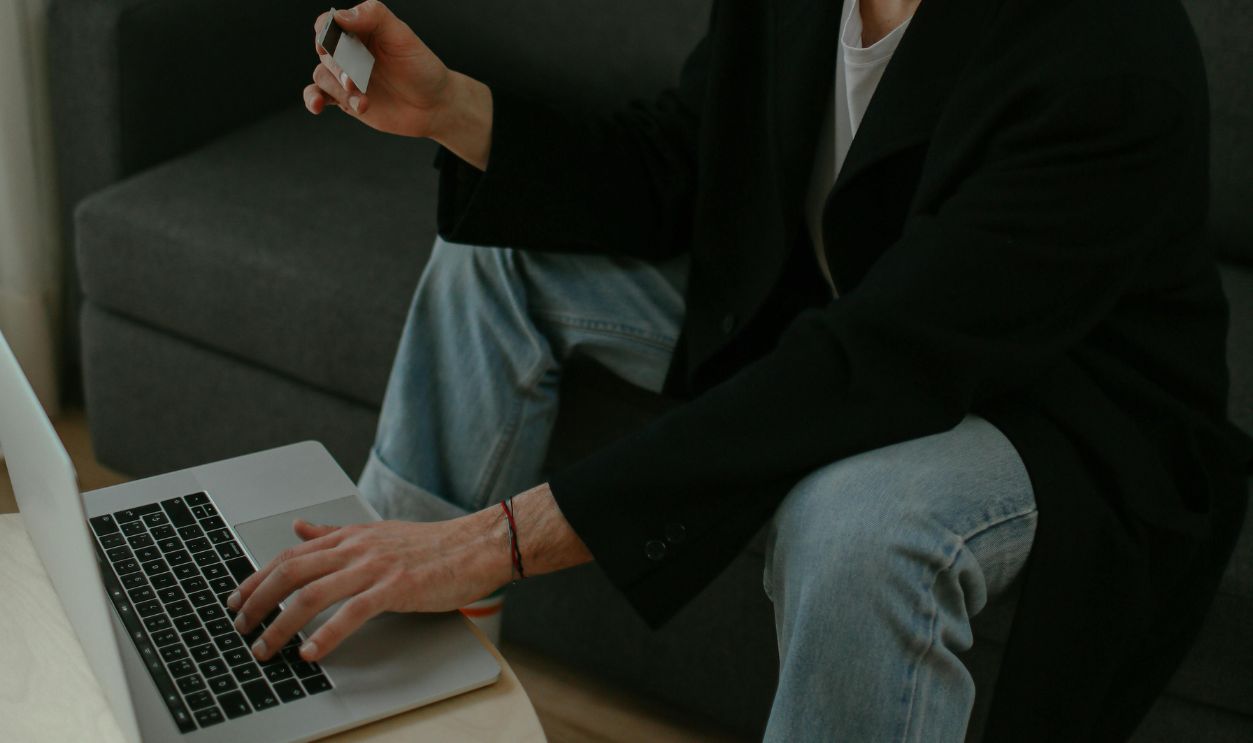 Man Using a Credit Card to Pay Online